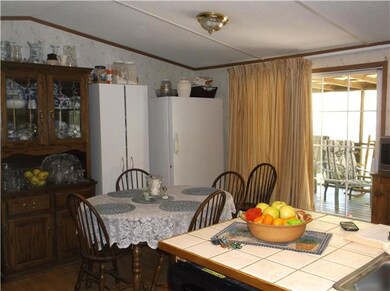 Spacious dining area with sliding doors leading to the nice covered and screened deck.