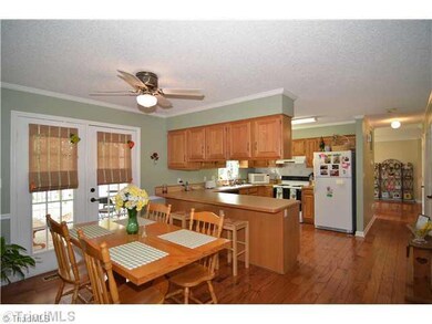Kitchen. You have a large kitchen with tons of storage space. There is a pantry to the right also. The atrium door to the back of the Dining Room leads you out into the Screened Porch.
