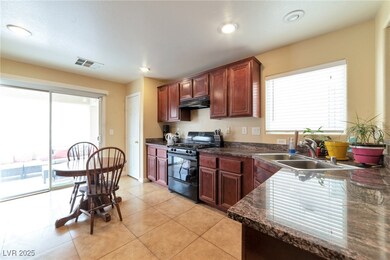 Kitchen with black gas range oven, visible vents,