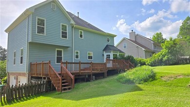 Rear view of property featuring a deck, an attache
