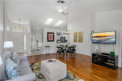 Living area with lofted ceiling, wood finished flo