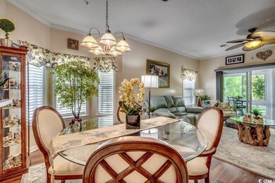 Dining room with ornamental molding, ceiling fan w