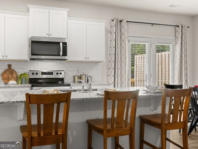 sudbury townhome kitchen with white cabinets and granite countertops at mountain park in dahlonega georgia