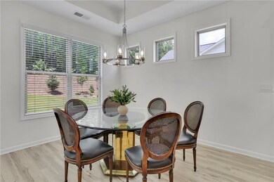 Dining area with a chandelier and light wood-style floors