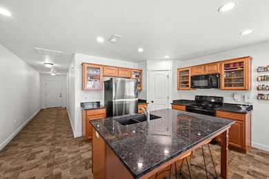 Kitchen with glass insert cabinets and large island with bar.