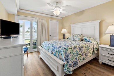 Bedroom with ceiling fan, access to exterior, dark