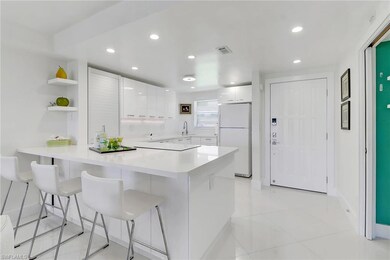 Kitchen with visible vents, a peninsula, white cab