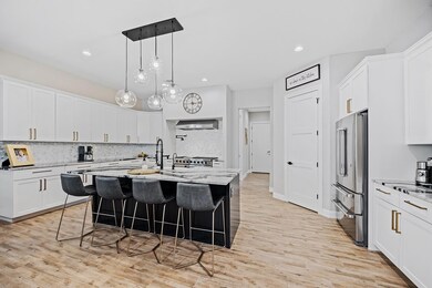 Kitchen featuring stainless steel appliances, wal