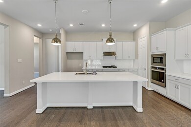This kitchen is by far any chef’s dream! This spacious kitchen features high ceilings, white stained wood cabinets, quartz countertops, SS appliances, modern tile backsplash, recessed lighting with additional custom pendant lighting, extended counter space, large kitchen island with space for breakfast bar, and a walk-in pantry all overlooking your huge family room.
