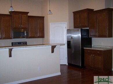Another view showing more cabinets next to refrige
