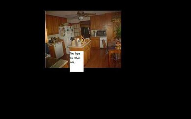 View from the other side of kitchen. Lots of cabinets.