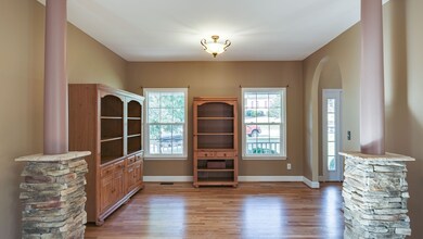 View of great room from the rear of home.  Bookcases are negotiable  New interior paint in warm taupe. 