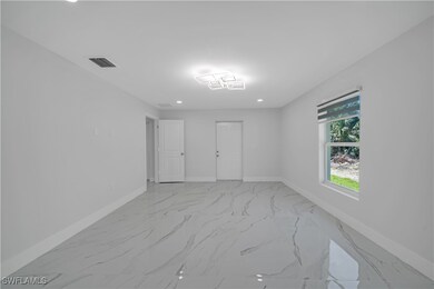 Empty room featuring baseboards, marble finish flo