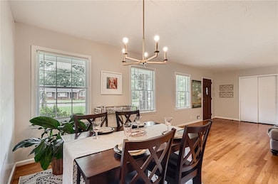Dining room featuring a chandelier, light wood-sty