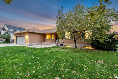 Ranch-style house featuring brick siding, a front yard, and an attached garage