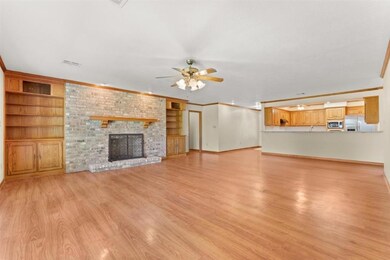 A 2nd view of the living area.  Entrance Foyer and Kitchen also shown.