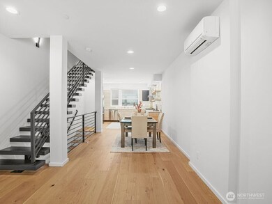 Beautiful, bright dining & kitchen with floating staircase.