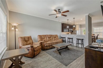 Living room with ceiling fan, light hardwood / woo