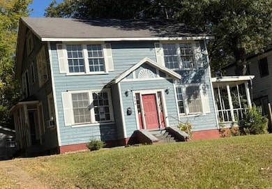 Colonial-style house with a front yard and entry steps