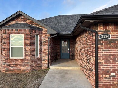 View of front facade featuring brick siding, roof 