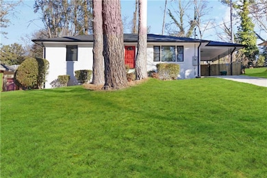 Single story home with driveway, an attached carpo