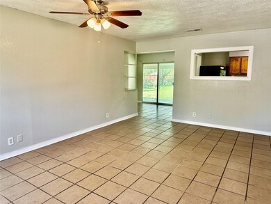 Empty room featuring baseboards, a textured ceilin