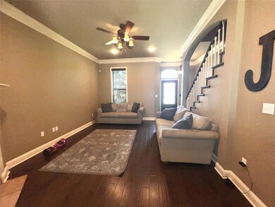 Living room with ornamental molding, ceiling fan, 