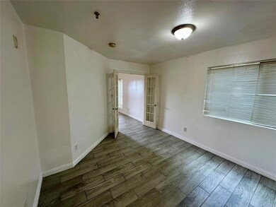 Spare room featuring baseboards and wood finished 