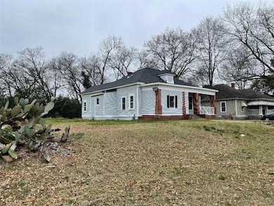 View of front of property featuring a front yard and a chimney