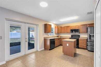 Double French Doors lead to the amazing screened in patio