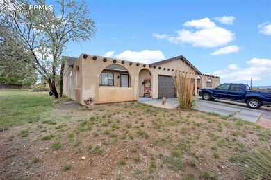 Southwest-style home with a garage, stucco siding,