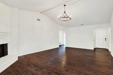 Wood floors accents the vaulted ceiling of the Gre
