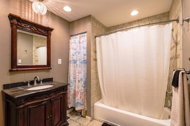 Primary bathroom featuring recessed lighting, tile