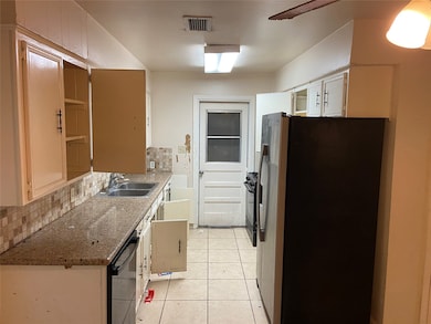 Galley kitchen with double sinks and dishwasher. The kitchen has plenty of cabinet space and a pantry not shown in this photo.