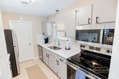 Kitchen featuring light tile patterned flooring, w