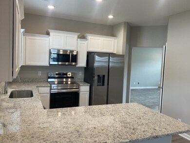 kitchen is equipped with all kitchen appliances. white  cabinets and granite tops