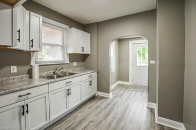 Kitchen featuring light countertops and white cabi