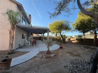 Fenced backyard with a patio, a pergola, and a ceiling fan