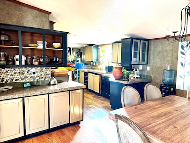 Kitchen featuring glass insert cabinets, dishwashe