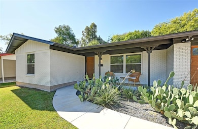 View of front of property with a front yard and b