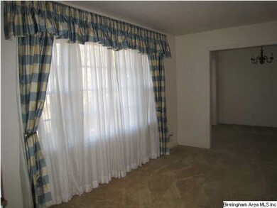 Living Room with beautiful draperies and open to D