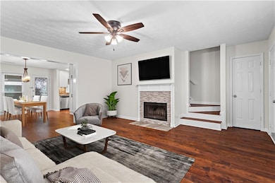 Living area with a ceiling fan, hardwood / wood-st