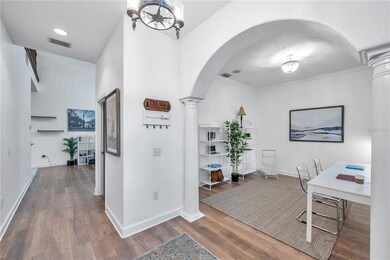 Additional sitting room or bonus space downstairs with view of front hallway. 