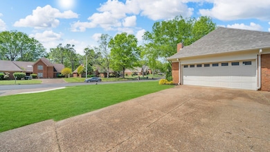 View of yard with concrete driveway, a residential
