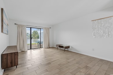 Empty room with wood finish floors and a water view