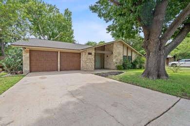 Mid-century modern home with stone siding, a gara