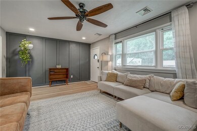 Living room featuring light wood-type flooring and ceiling fan