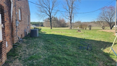 View of grassy yard with central AC
