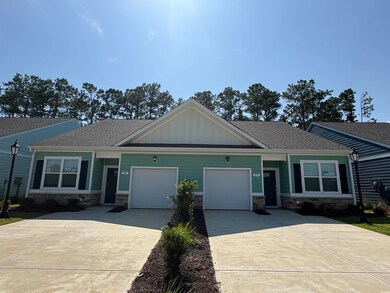 Craftsman inspired home featuring concrete driveway, a garage, stone siding, board and batten siding, and roof with shingles