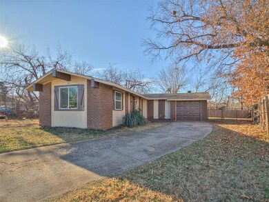 View of side of home with fence, driveway, an atta